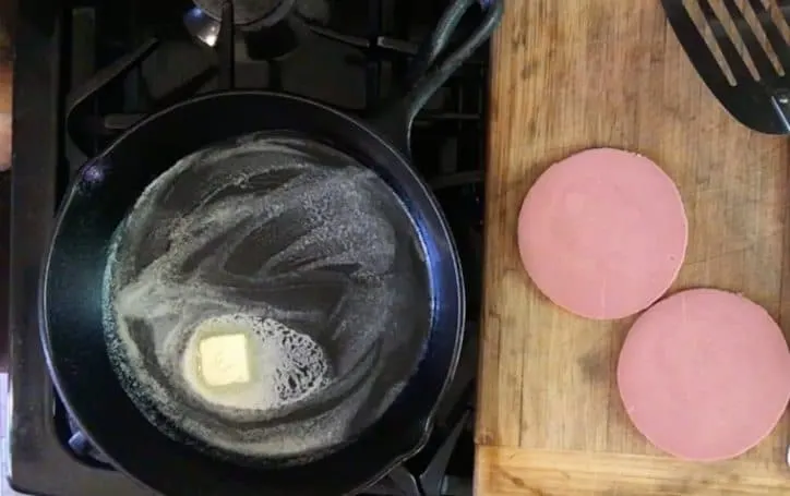 butter melting in a cast iron skillet for how to fry bologna