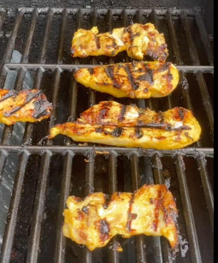 chicken cooking on the grill