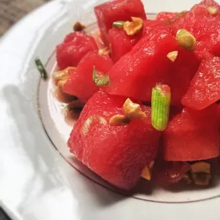 close up of watermelon grapefruit salad on a white plate