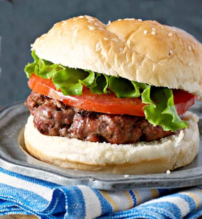 hamburger on a plate with blue napkin