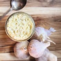 garlic and jar on cutting board