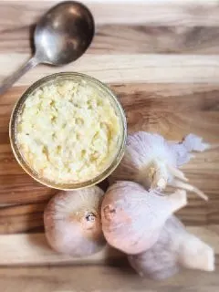 garlic and jar on cutting board