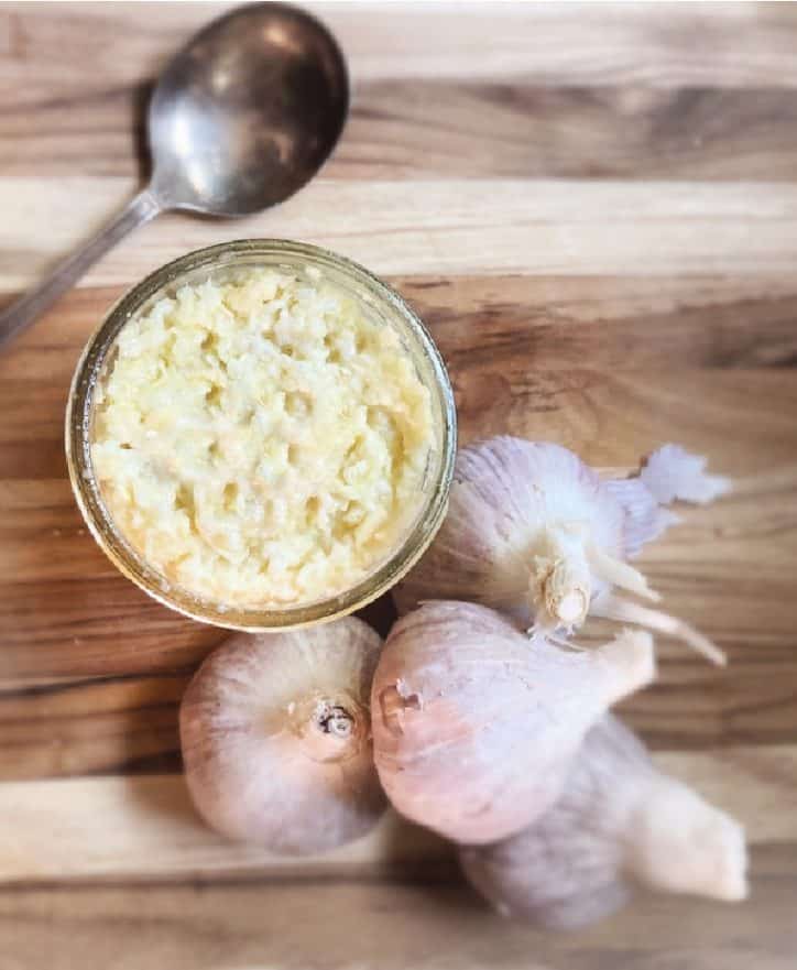 garlic and jar on cutting board