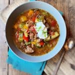 bowl of soup on table with spoon