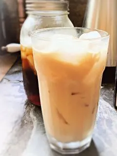 glass of vanilla iced coffee on table
