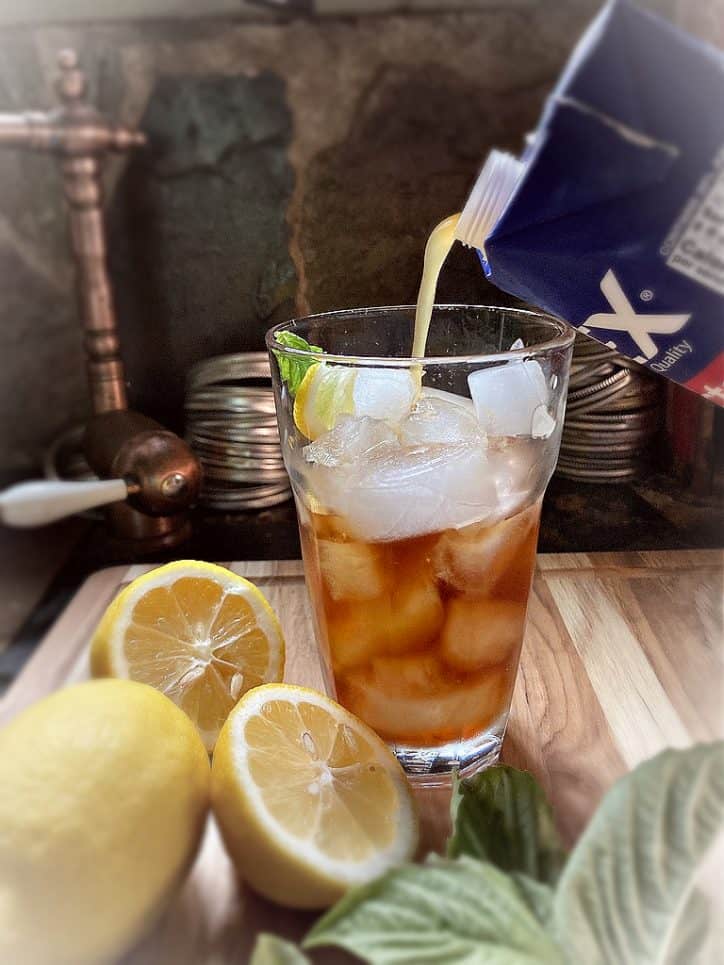 glass of ice and ingredients on table
