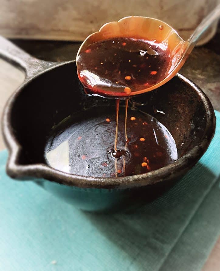 cast iron sauce pan with cheerwine barbecue sauce