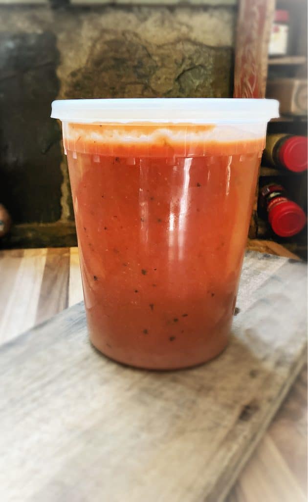 quart container of soup on cutting board
