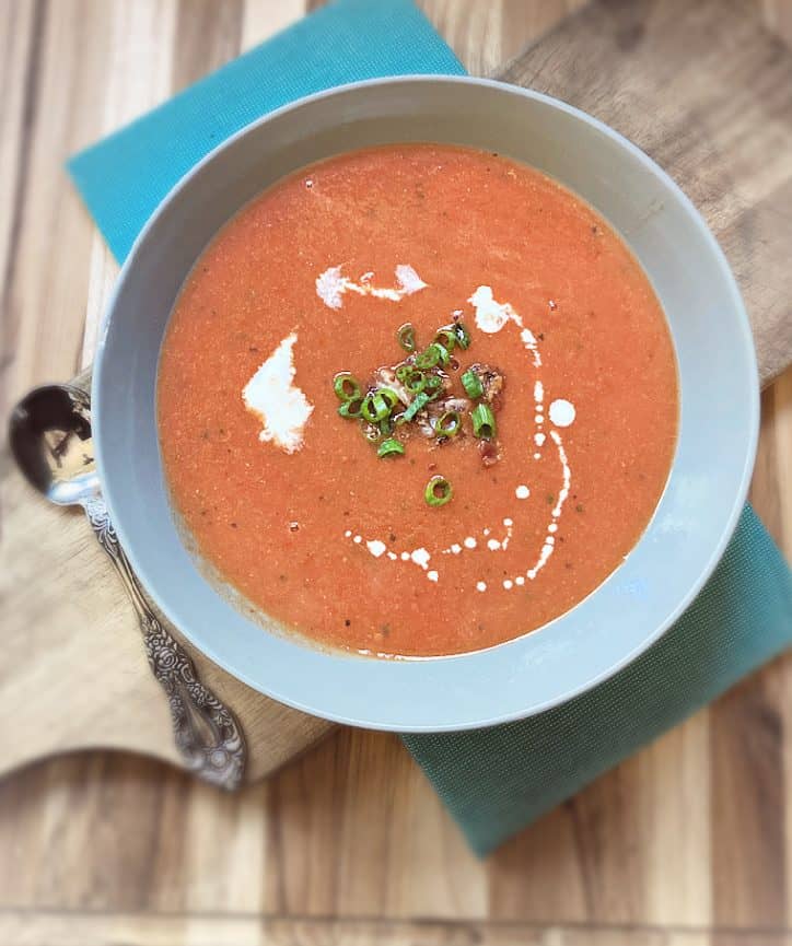 overhead view of bowl of soup on cutting board.