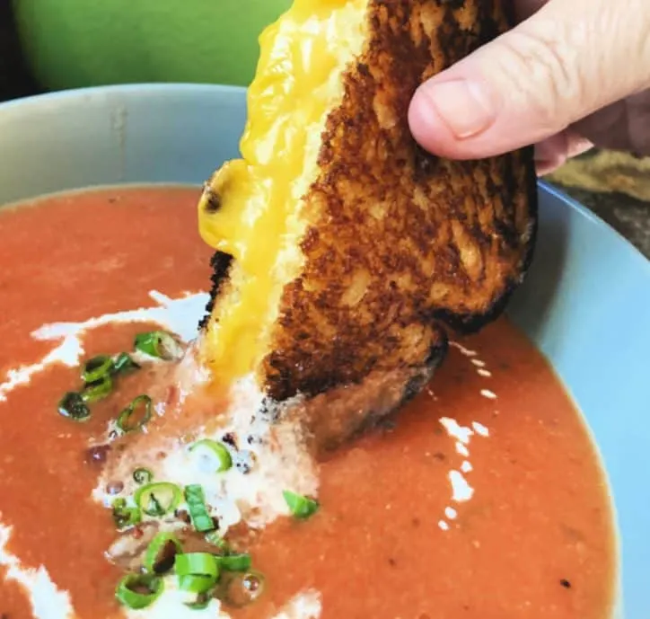 dipping grilled cheese into soup