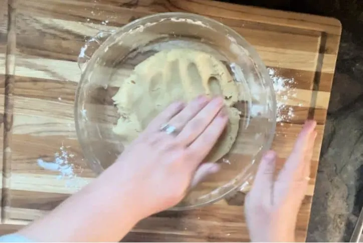 hand patting out pie crust