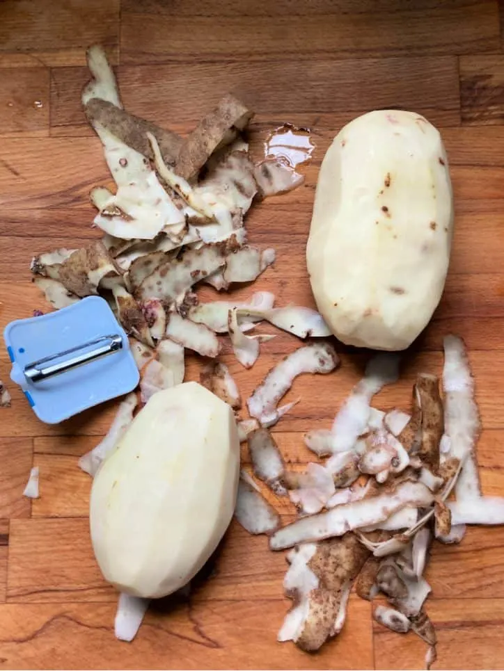 peeled potato on board