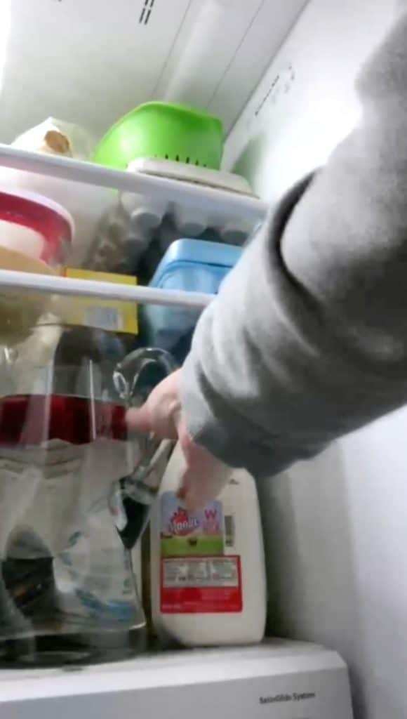 putting drink in fridge