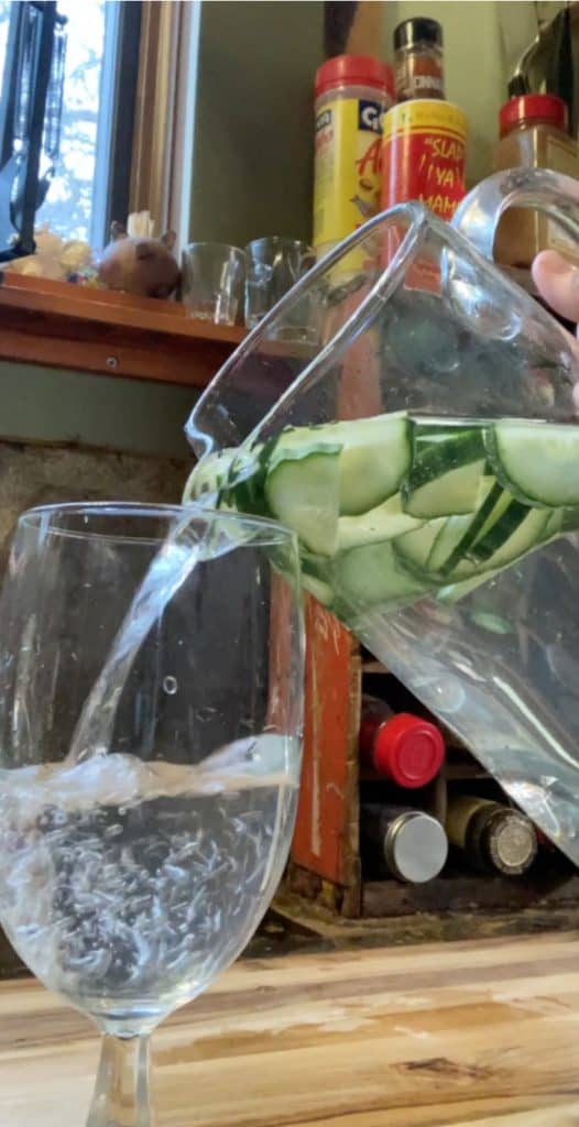 pour glass of cucumber water