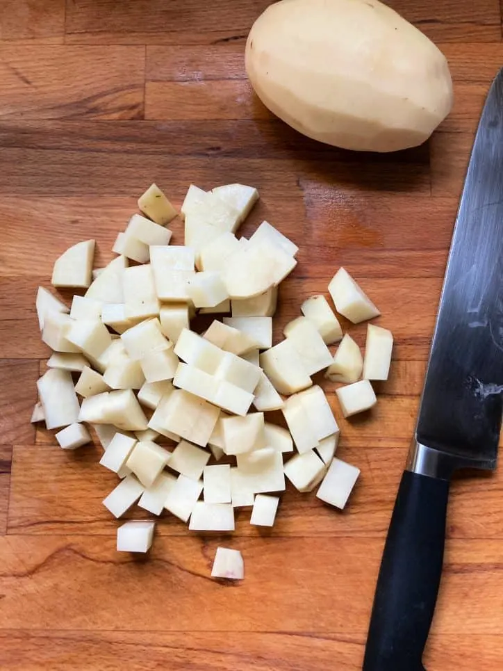 cut up potato on cutting board
