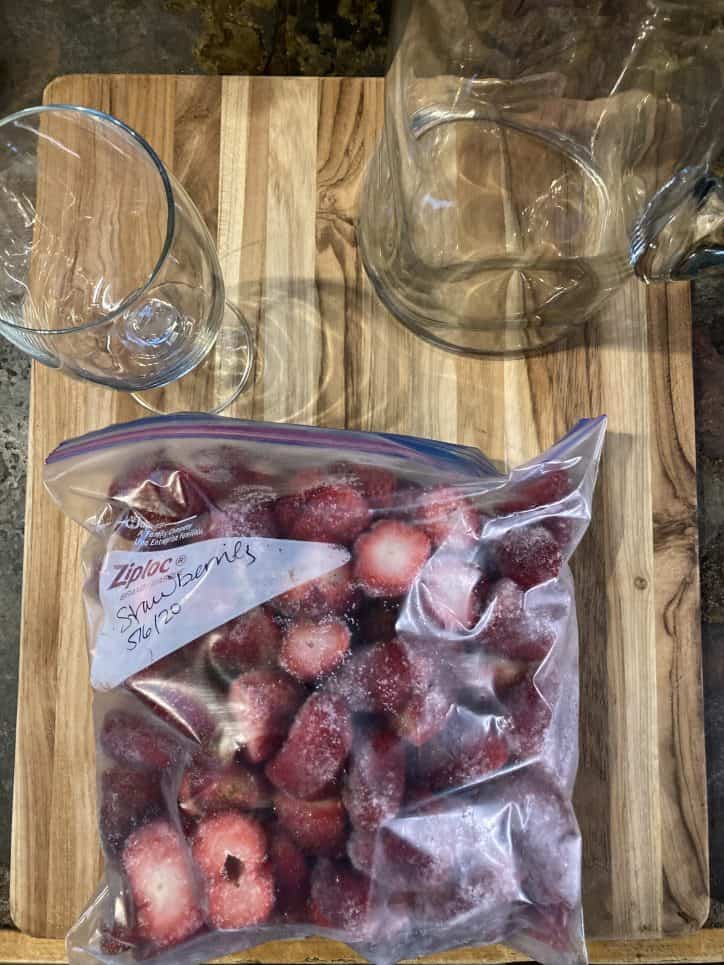 strawberries and glasses on table