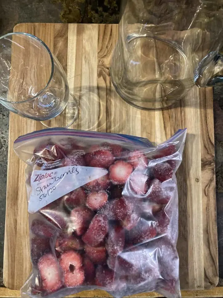 strawberries and glasses on table