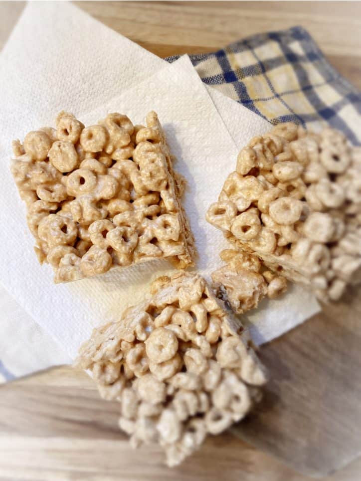 three peanut butter cheerio bars on table