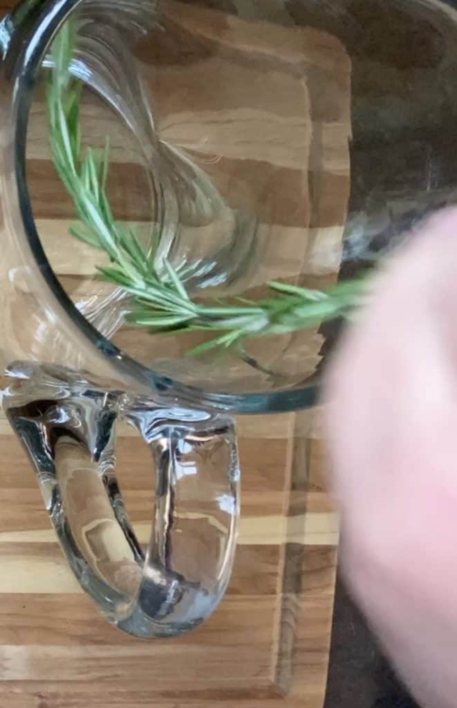 placing rosemary in pitcher