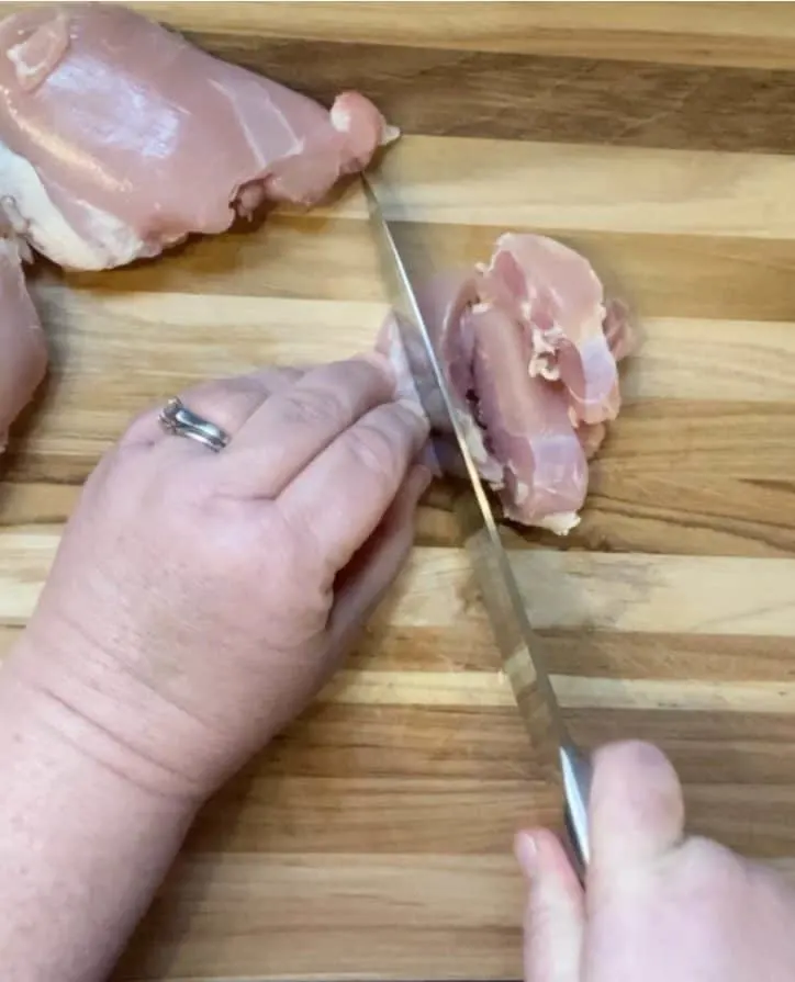 cutting chicken on board