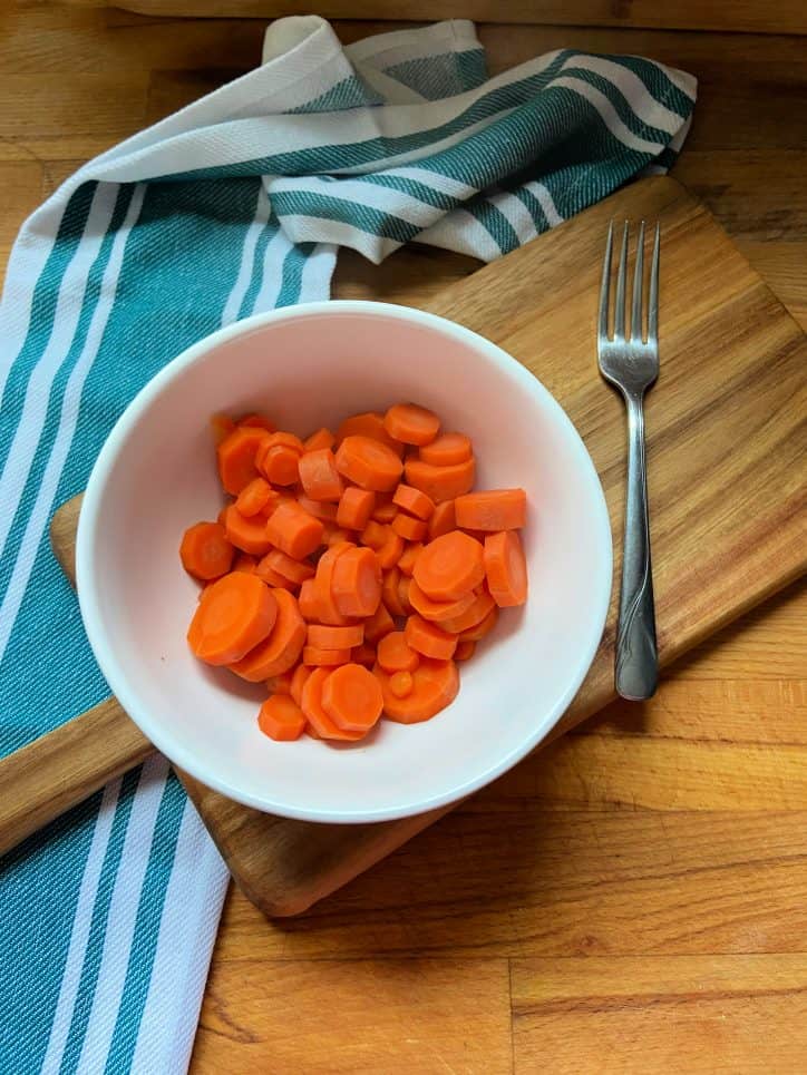 Sliced carrots in white bowl 