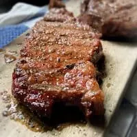 smoked ribeye steak on cutting board