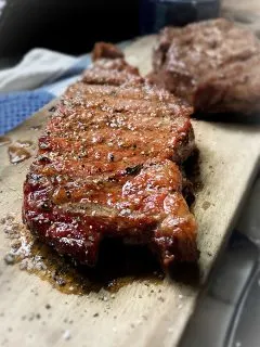 smoked ribeye steak on cutting board