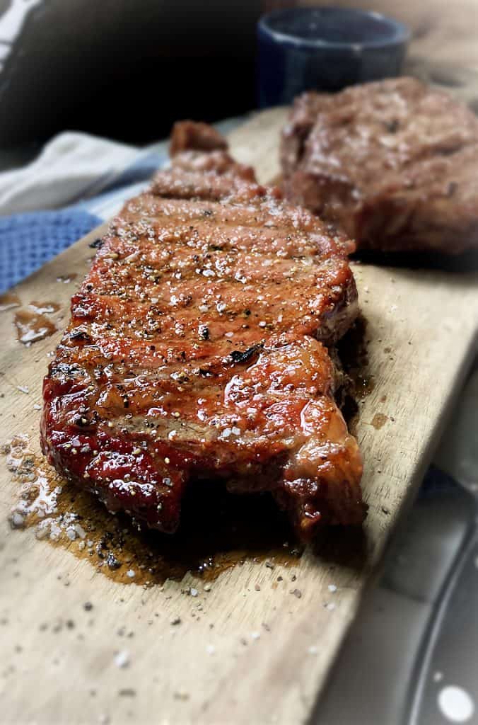 smoked ribeye steak on cutting board