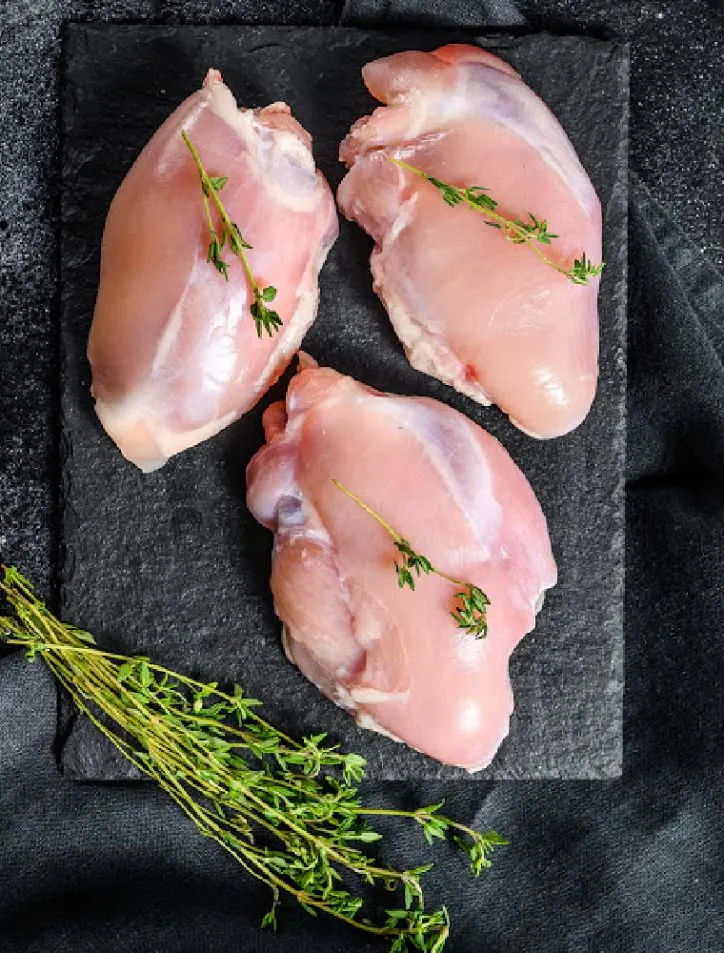 chicken thighs on a cutting board