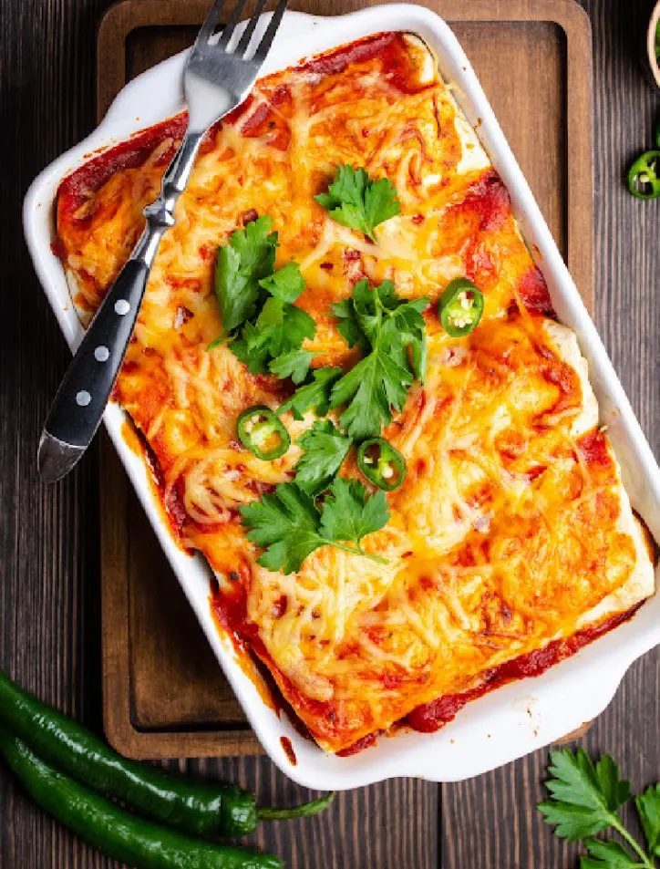 chili relleno casserole with enchilada sauce on table