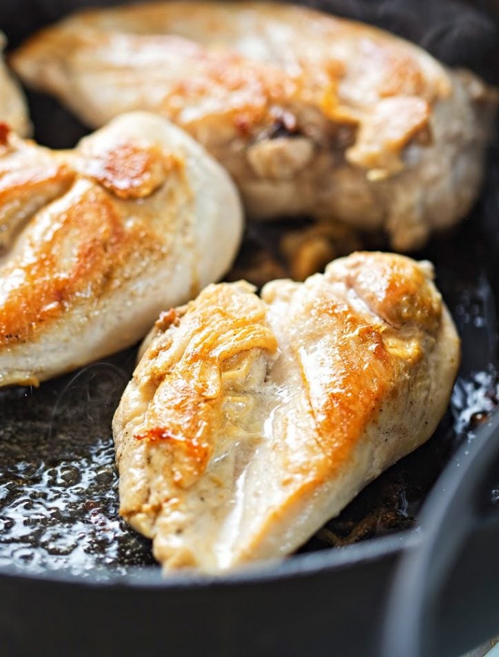 Close up of chicken breasts in a skillet