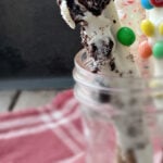 pretzel rods covered in white chocolate and oreos.