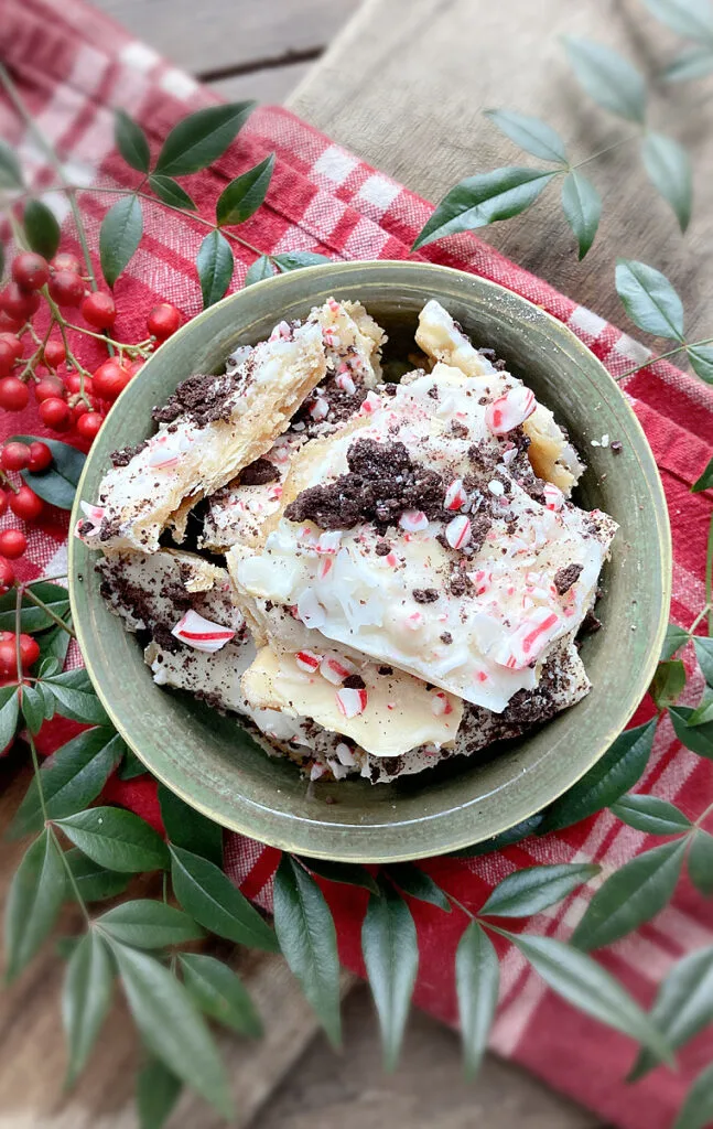 bowl of white chocolate saltine toffee with oreos and peppermints