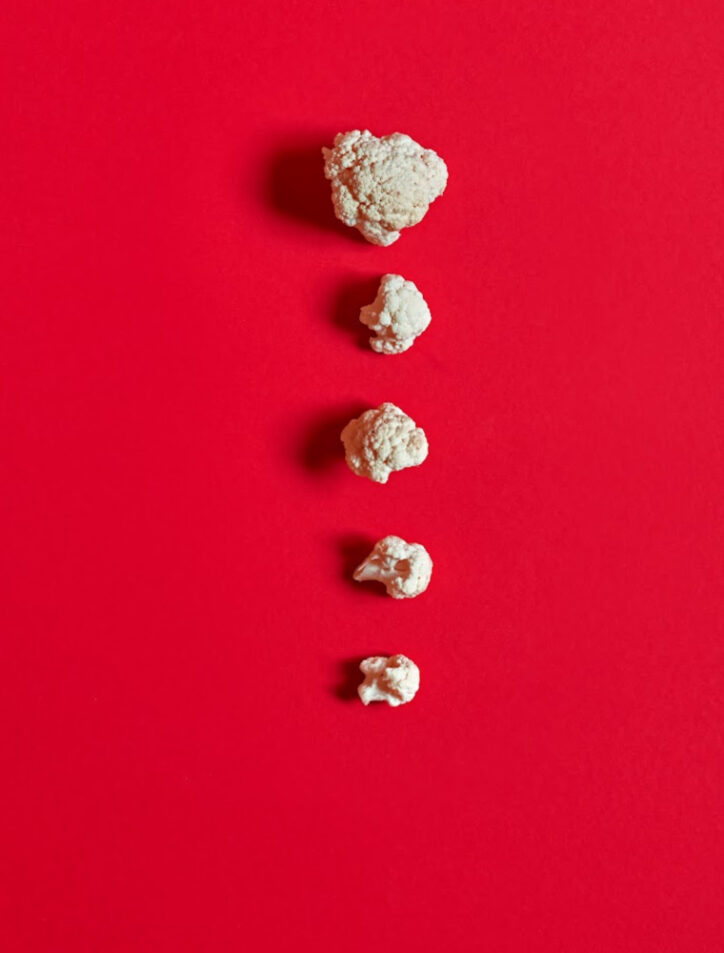 cauliflower florets on red background