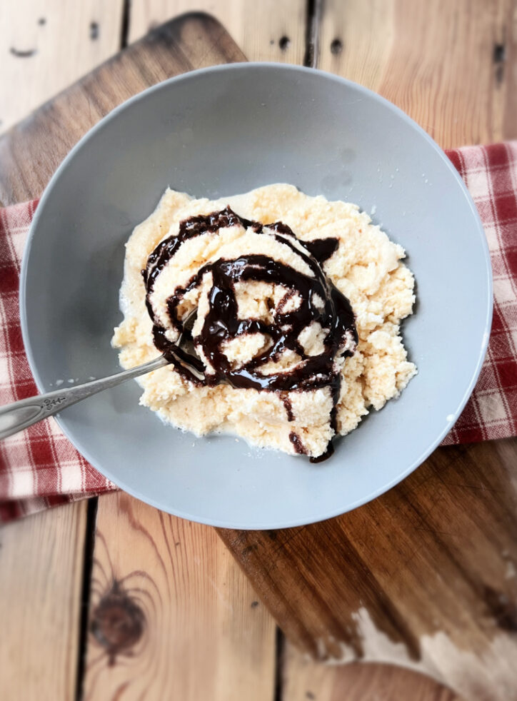 bowl of snow cream with chocolate sauce