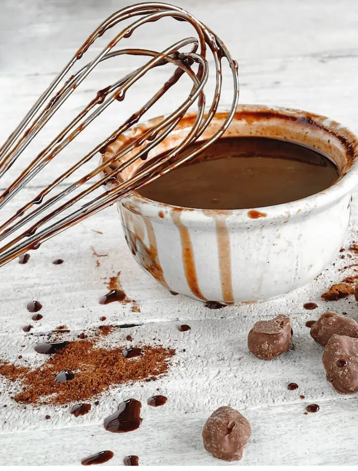 bowl of thick hot fudge sauce and whisk