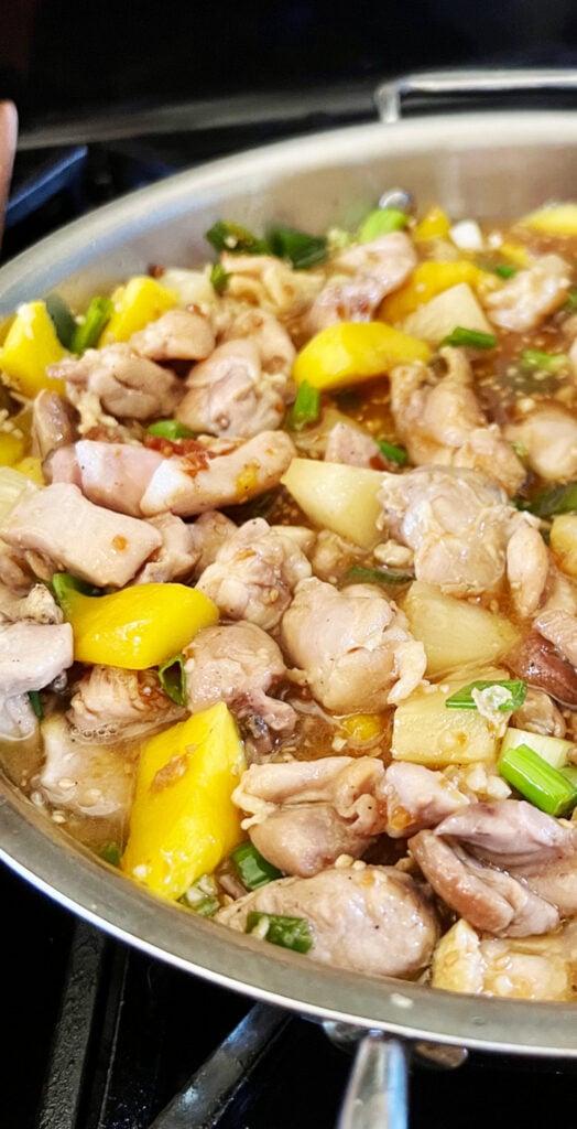 frying pan of pineapple mango chicken