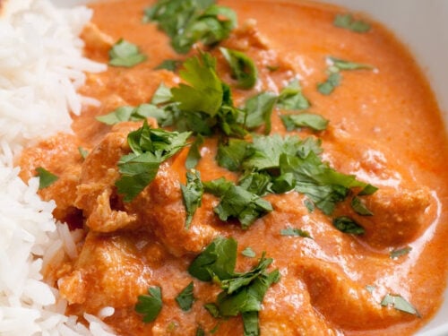 chicken with a red sauce and rice