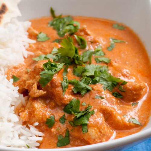 chicken with a red sauce and rice
