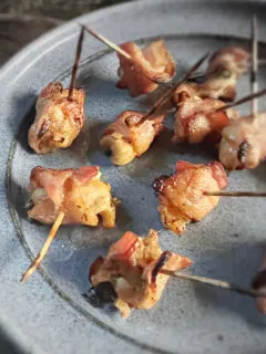 bacon wrapped chicken bites on blue plate