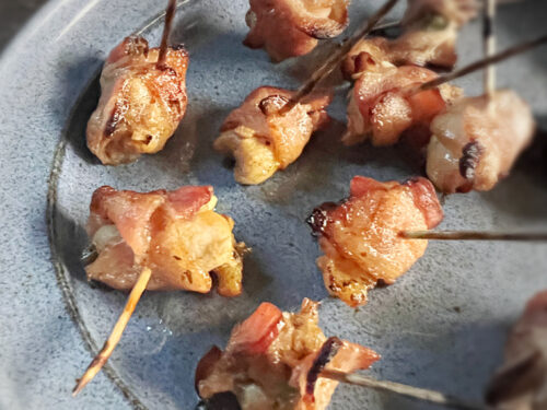 bacon wrapped chicken bites on blue plate