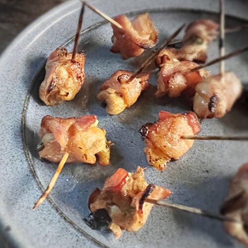 bacon wrapped chicken bites on blue plate