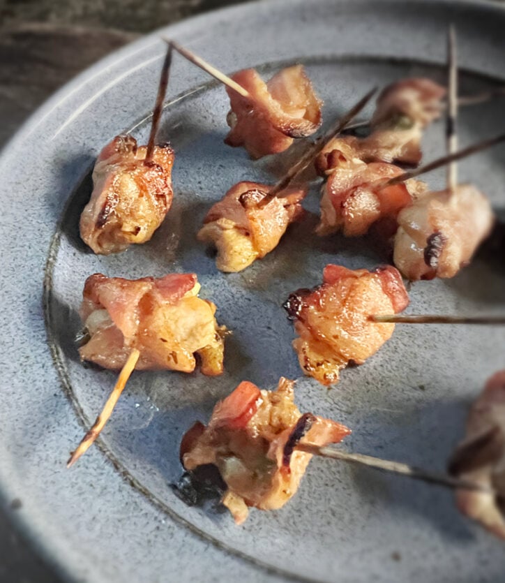 bacon wrapped chicken bites on blue plate