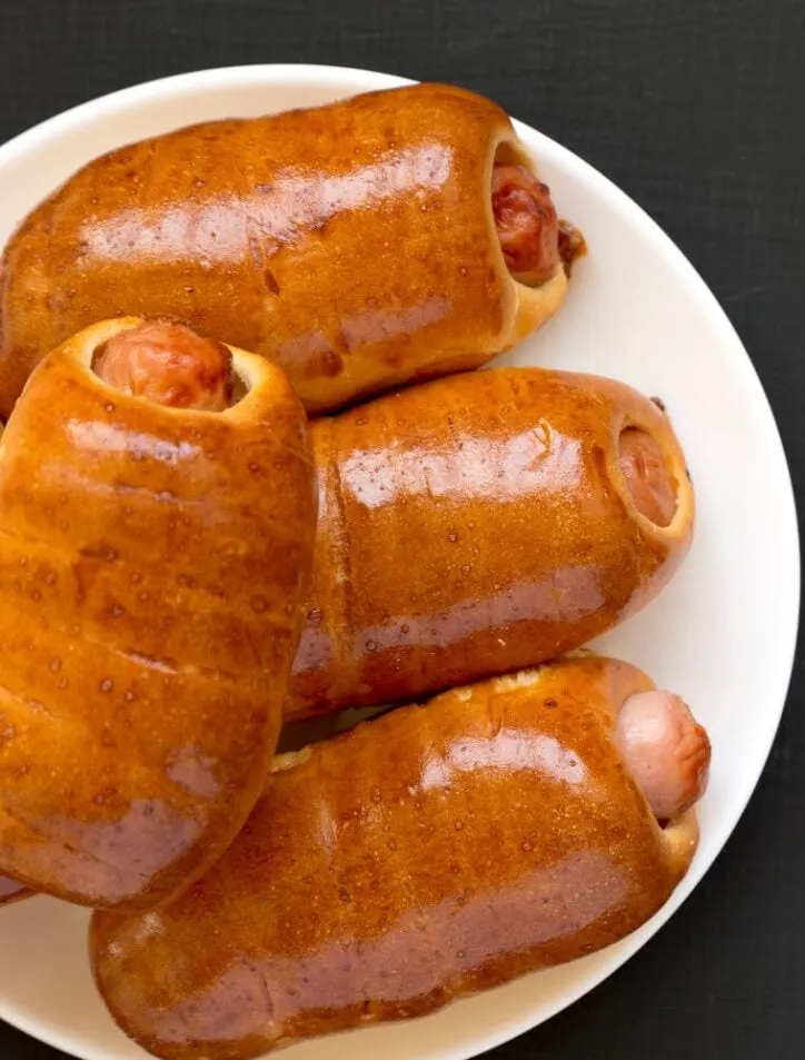 Pigs in a blanket with little smokies on white plate