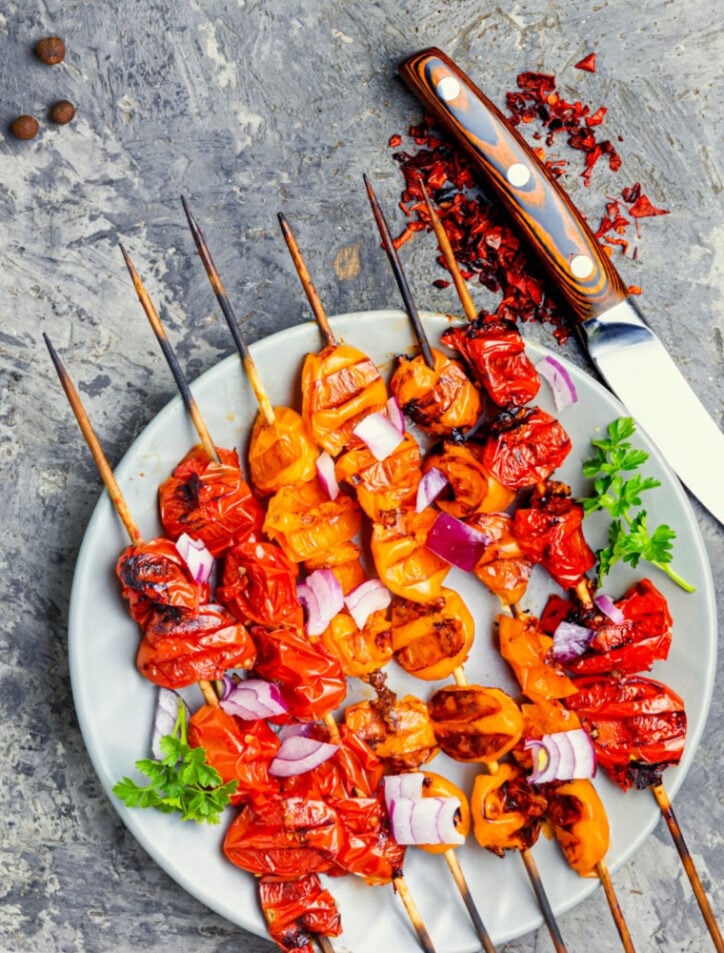 tomato kabobs on plate with knife