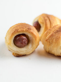 pigs in a blanket with little smokies on white background