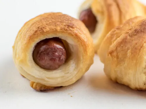 pigs in a blanket with little smokies on white background