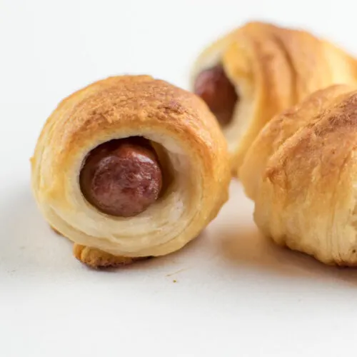 pigs in a blanket with little smokies on white background