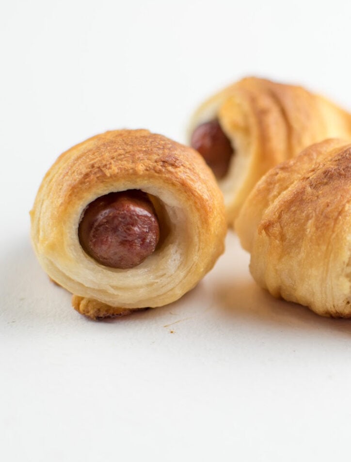 pigs in a blanket with little smokies on white background