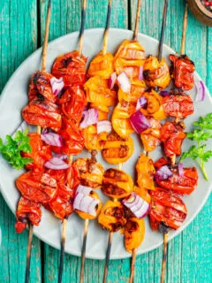 how to cut tomatoes for kabobs on blue background